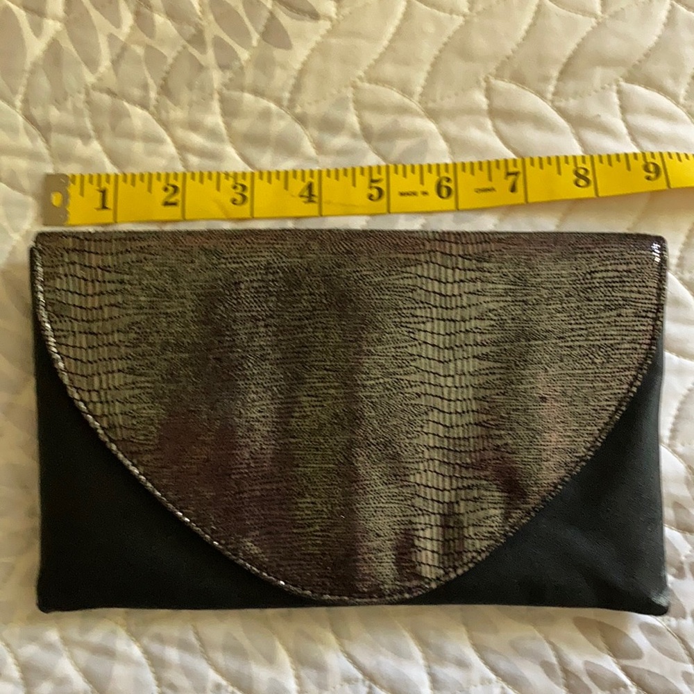 Snakeskin clutch used once with 2 marks that can be covered with marker. $ firm
